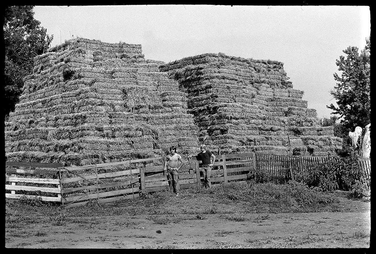 Nile and I standing by the haybales Two boys standing by haybales